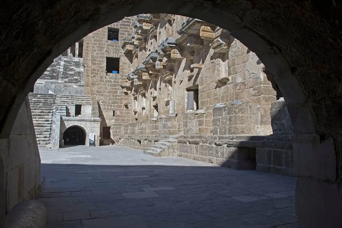 The intact stage building of the Roman theatre at Aspendos seen through an arch