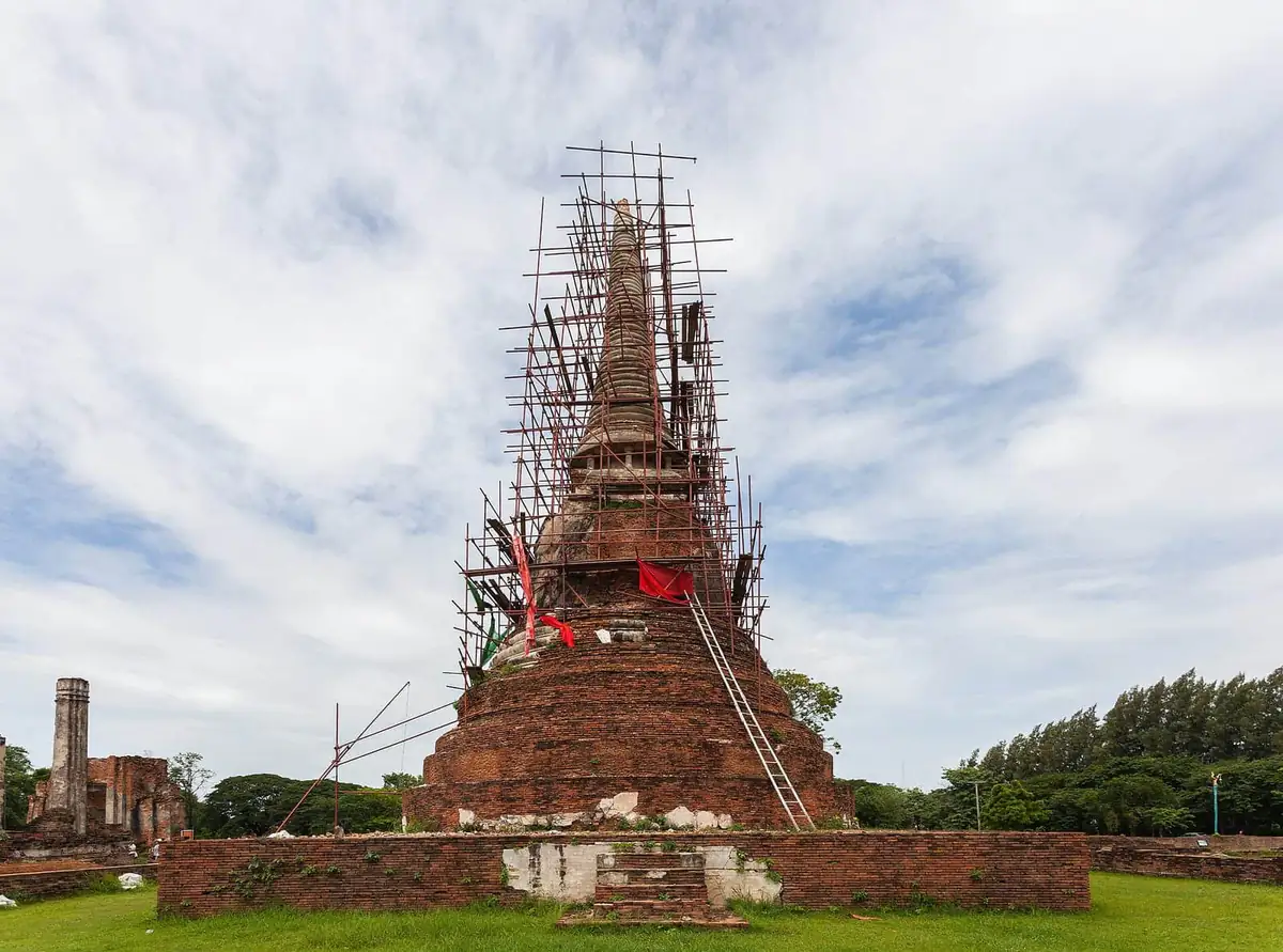 A brick chedi at Wat Mahathat surrounded by restoration scaffolding
