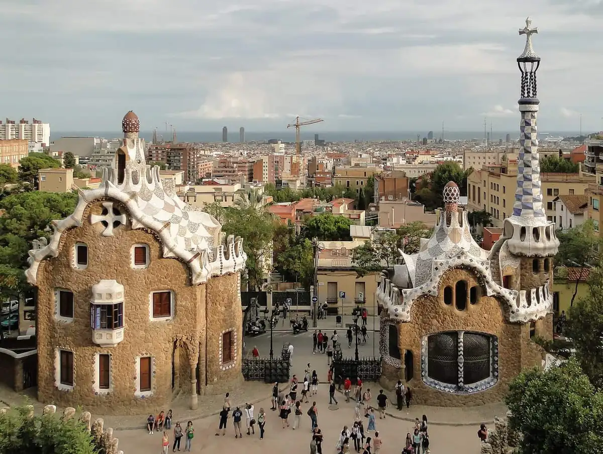 The two gatehouse pavilions at the entrance to Park Guell, with Barcelona beyond