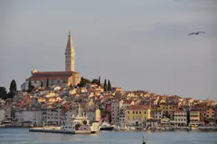 Rovinj old town and church tower glowing at sunrise