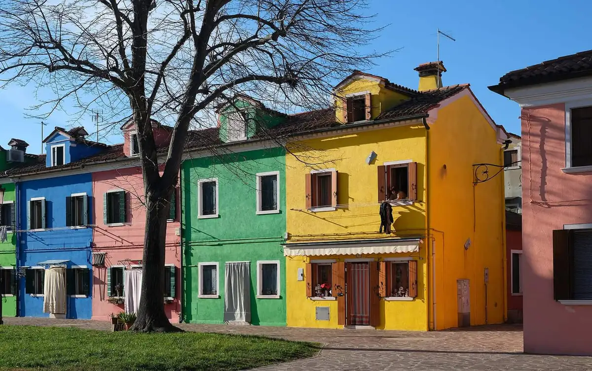 Colourful houses on Burano island near Venice under a blue sky