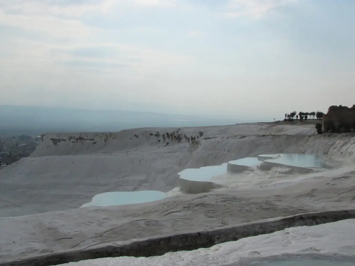 White travertine terraces with shallow blue pools at Pamukkale
