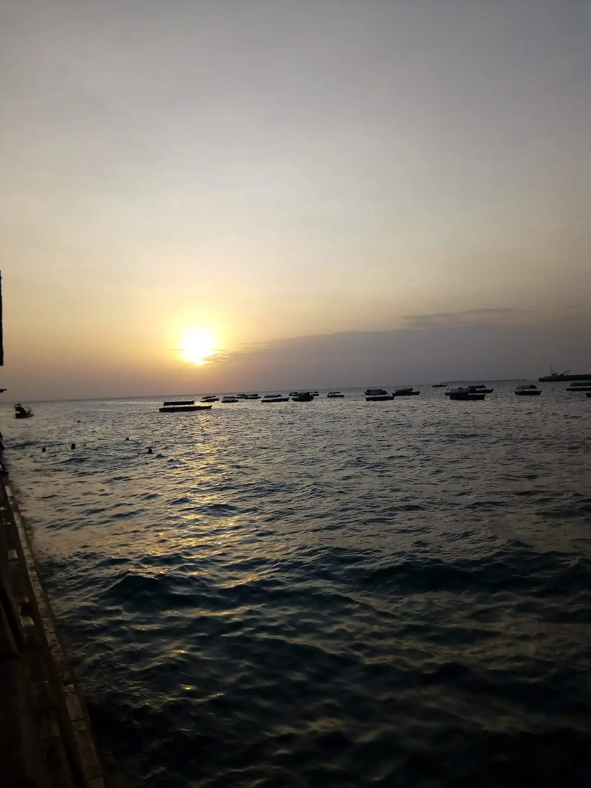 Boats anchored off the Stone Town seafront at sunset