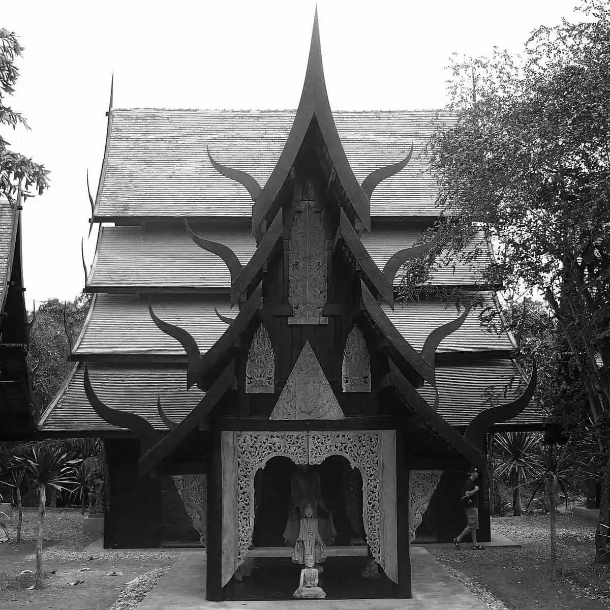 A dark carved wooden pavilion at Baan Dam, the Black House, north of Chiang Rai