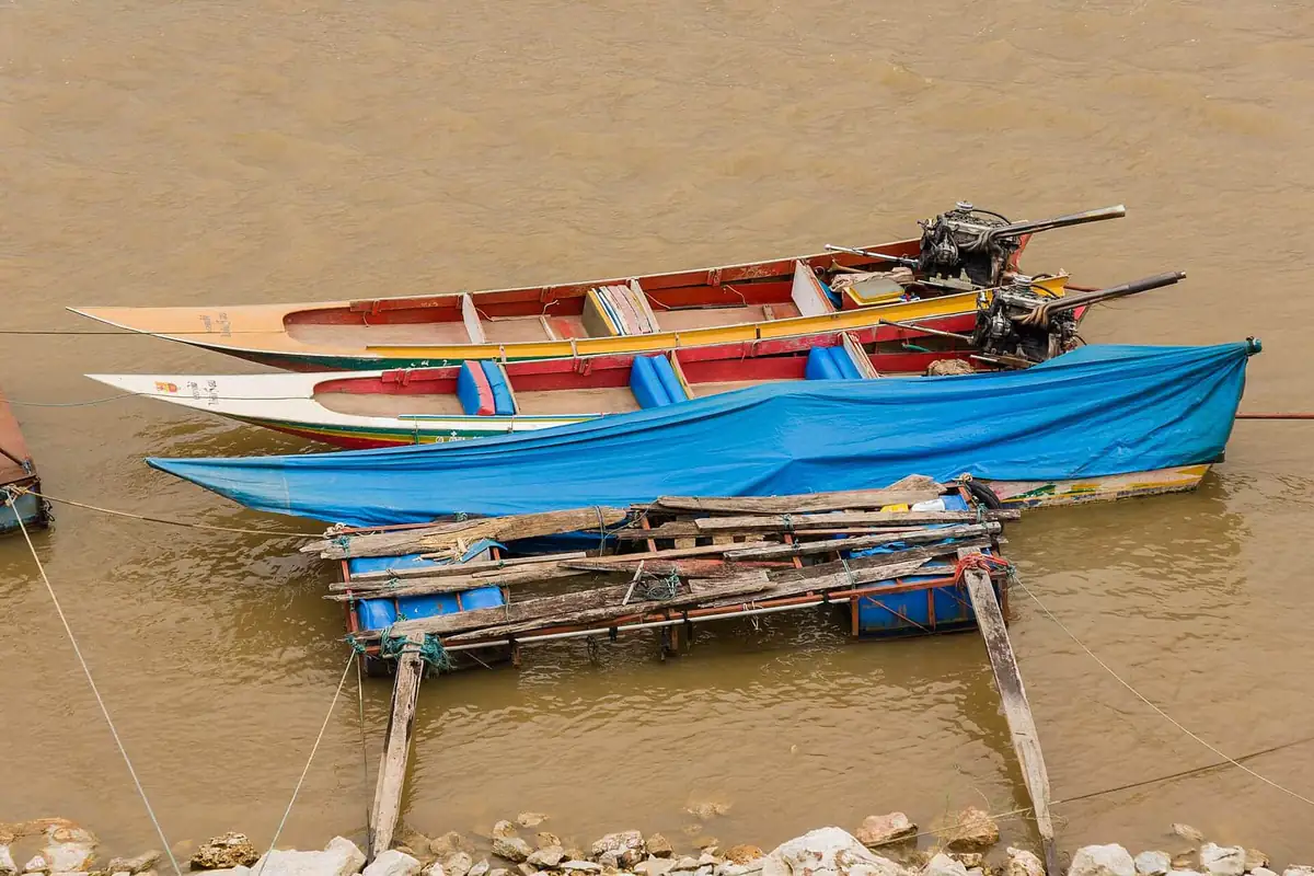 Longtail boats on the brown Mekong at Sop Ruak in the Golden Triangle