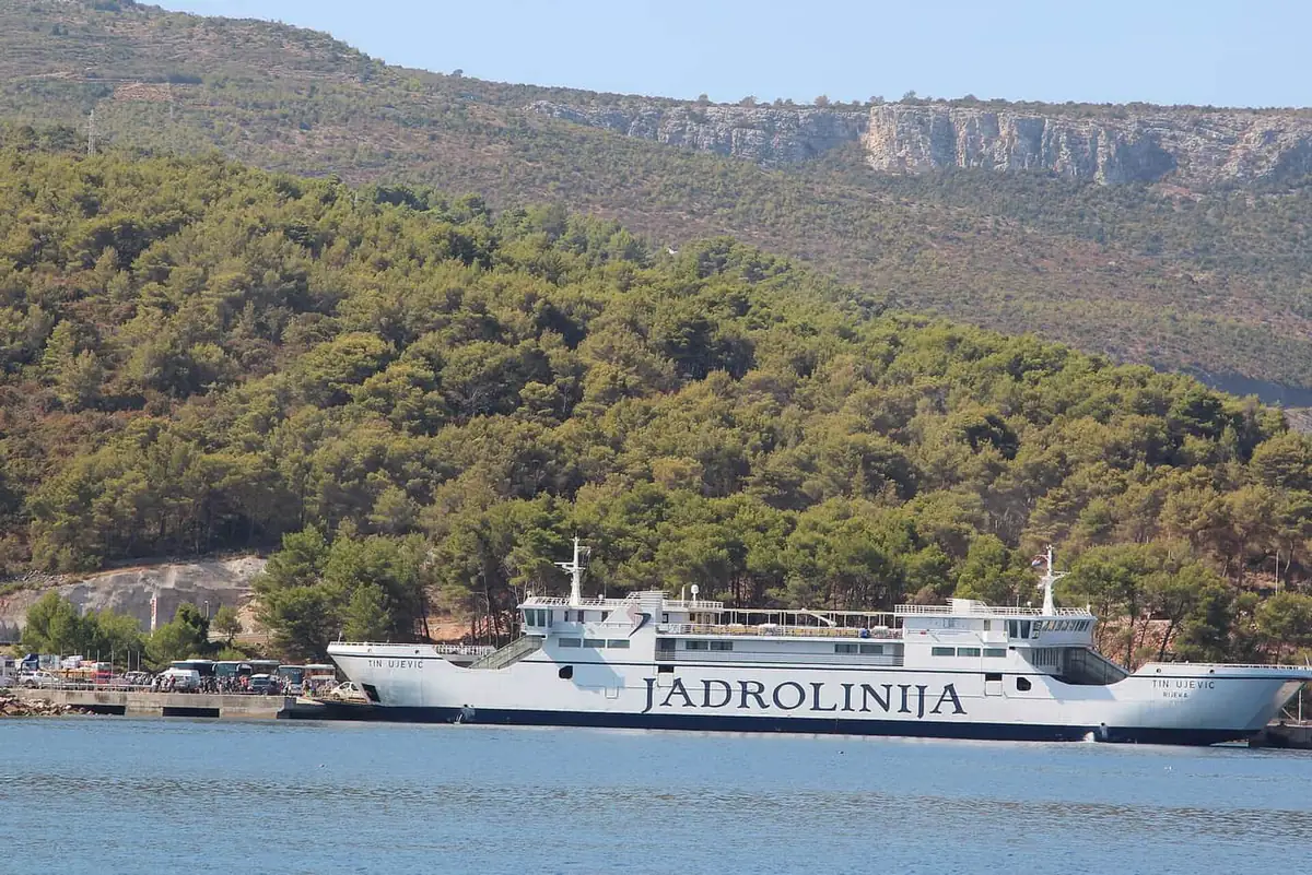 The Jadrolinija car ferry Tin Ujević tied up at the ferry port of Stari Grad on Hvar, with pine woods behind