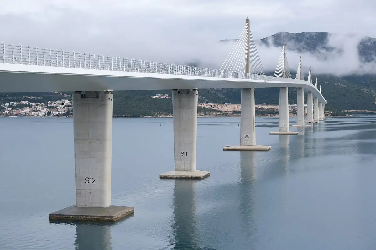 The Pelješac Bridge spanning the bay with mountains behind
