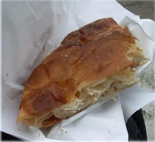 A cheese burek slice in paper