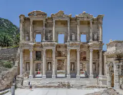 The two-storey marble facade of the Library of Celsus at Ephesus under a clear sky