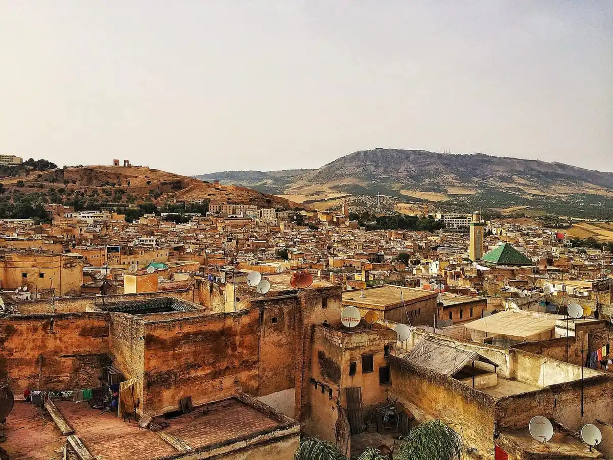 Rooftops of the Fes medina with satellite dishes, looking toward the hills