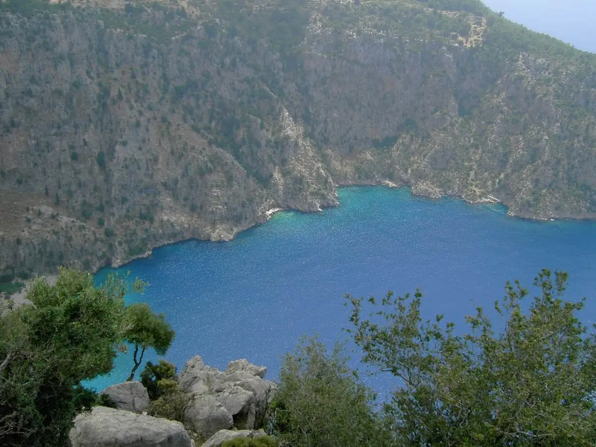 Butterfly Valley, a steep-sided cove with turquoise water, seen from the cliffs above
