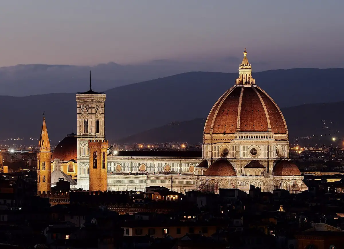 The Florence Duomo and its dome lit up at dusk, seen from Michelangelo hill