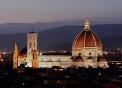 The Florence Duomo and its dome lit up at dusk, seen from Michelangelo hill