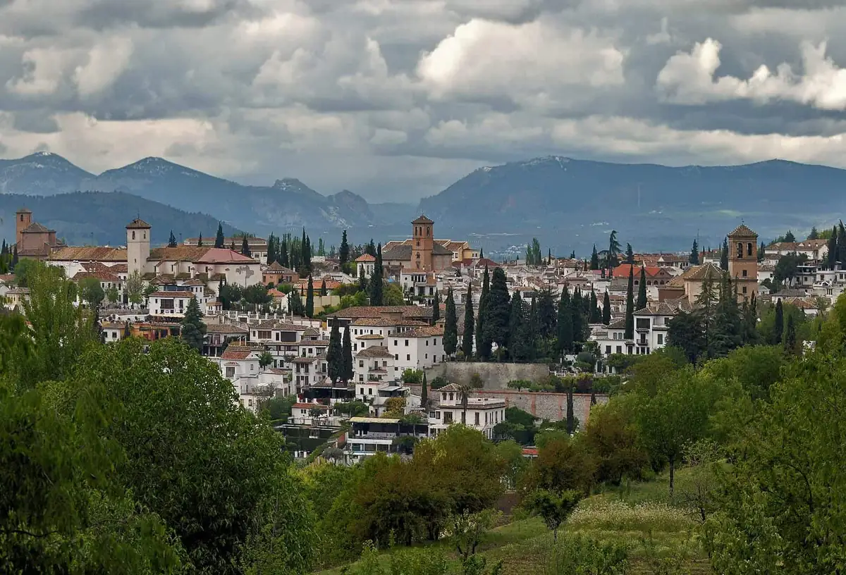 Whitewashed houses of the Albaicín seen from the Alhambra, with the Sierra Nevada mountains behind