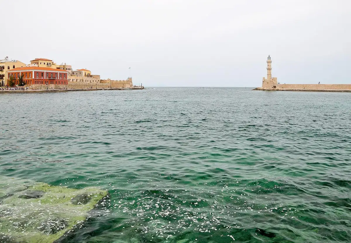 The Venetian lighthouse and waterfront buildings of the old harbour at Chania, Crete