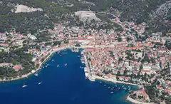 Aerial view of Hvar Town harbour with the fortress hill behind