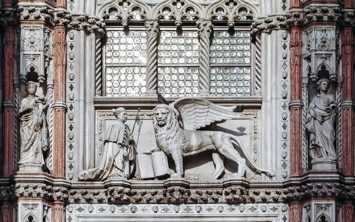 Sculpted detail of the Porta della Carta on the Doge's Palace in Venice, showing the Doge kneeling before the winged lion