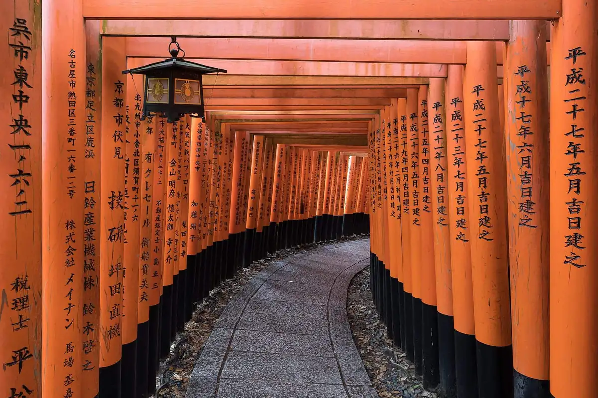 Vermilion torii gates curving up the path at Fushimi Inari Taisha