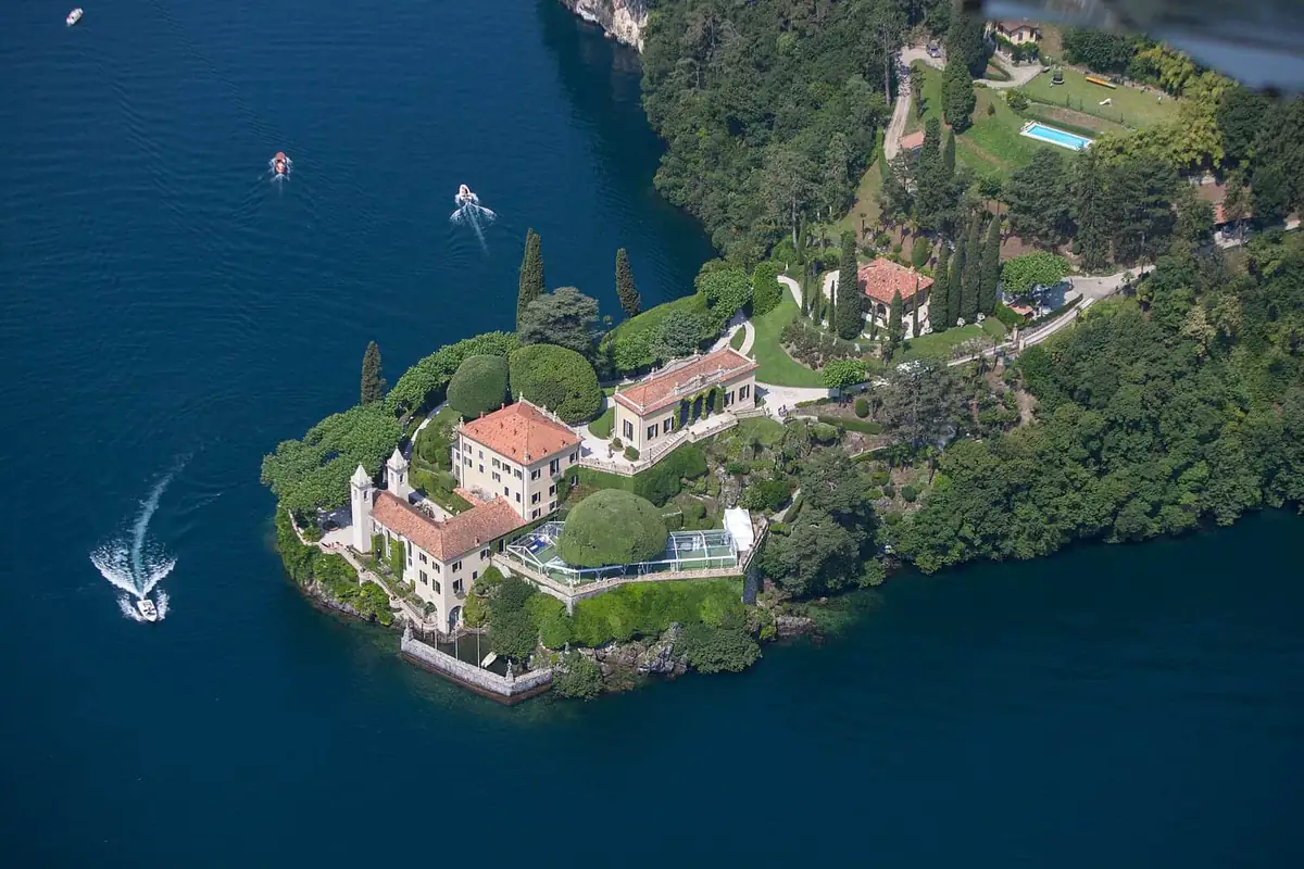 Villa del Balbianello seen from the air on its wooded point above Lake Como