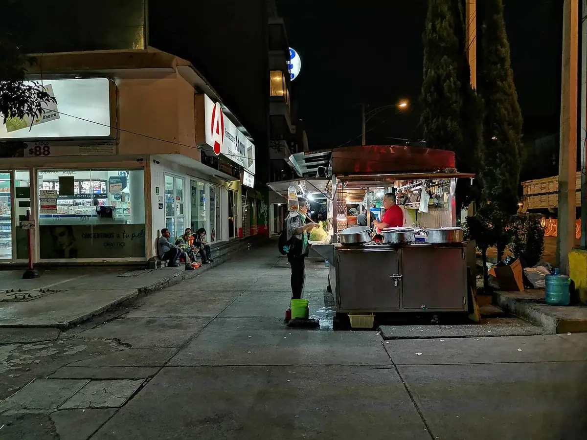 A lit taco stand serving the night crowd