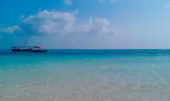 Clear turquoise water off Nungwi beach with wooden boats moored offshore