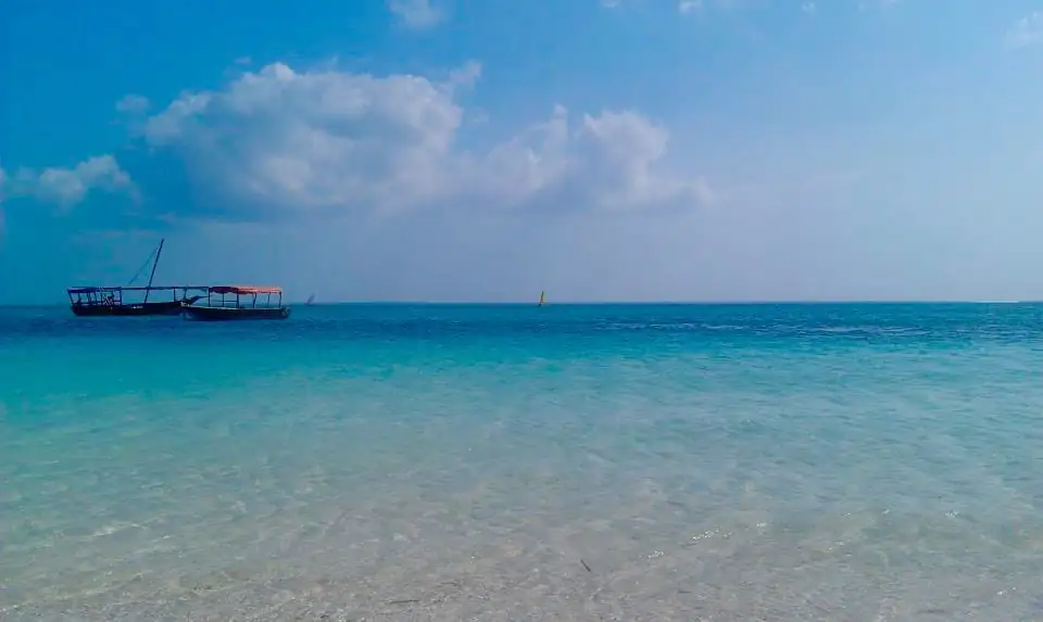 Clear turquoise water off Nungwi beach with wooden boats moored offshore