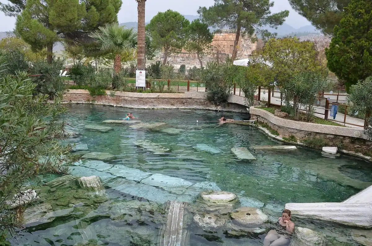 Swimmers in the Antique Pool at Hierapolis, above fallen marble columns in clear water