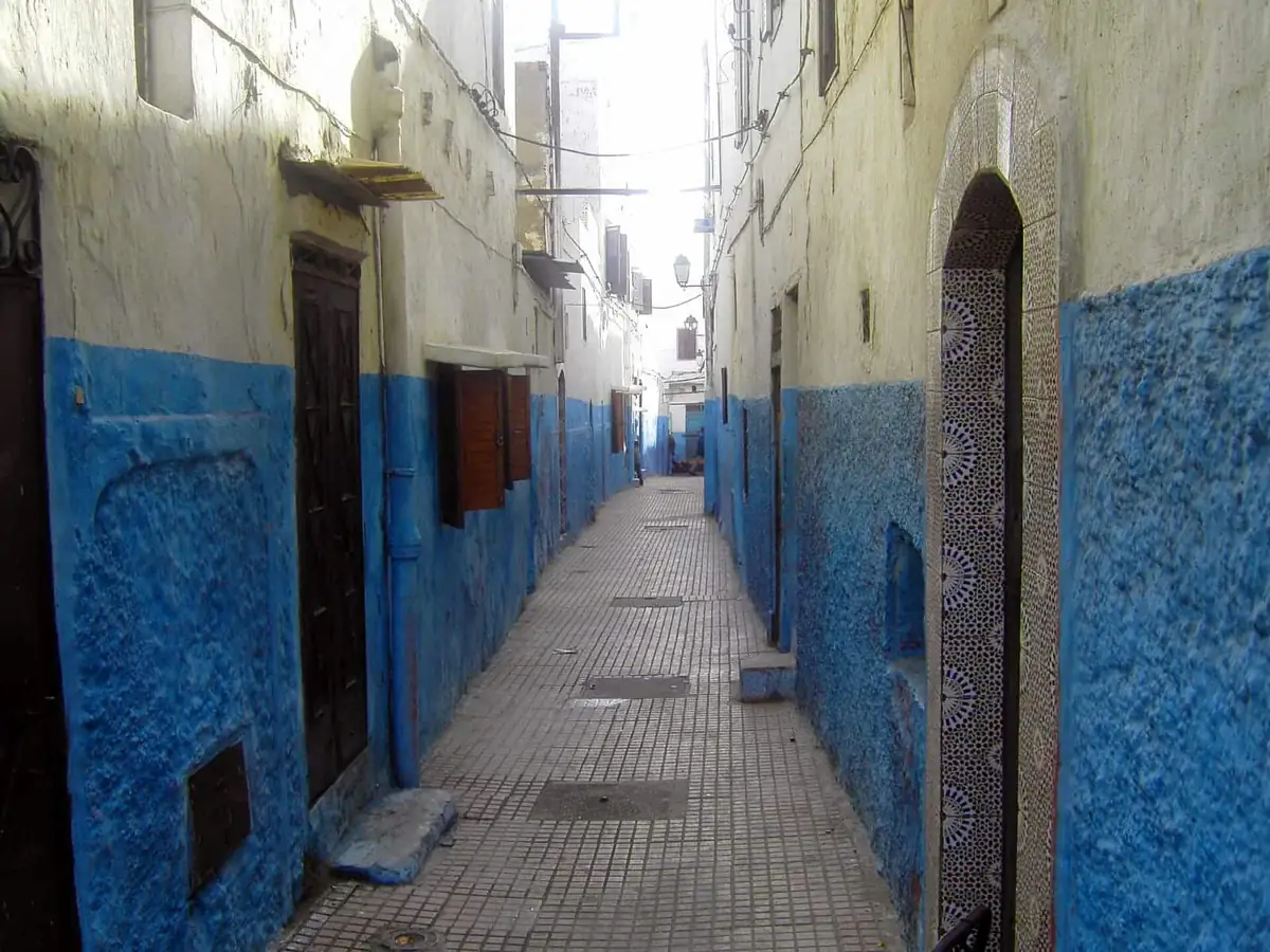 A quiet blue-and-white lane with tiled doorways inside the Kasbah of the Udayas