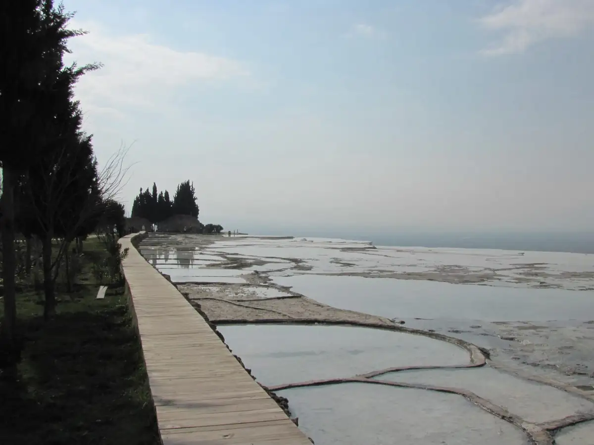 White travertine pools and a boardwalk stretching across the Pamukkale terraces