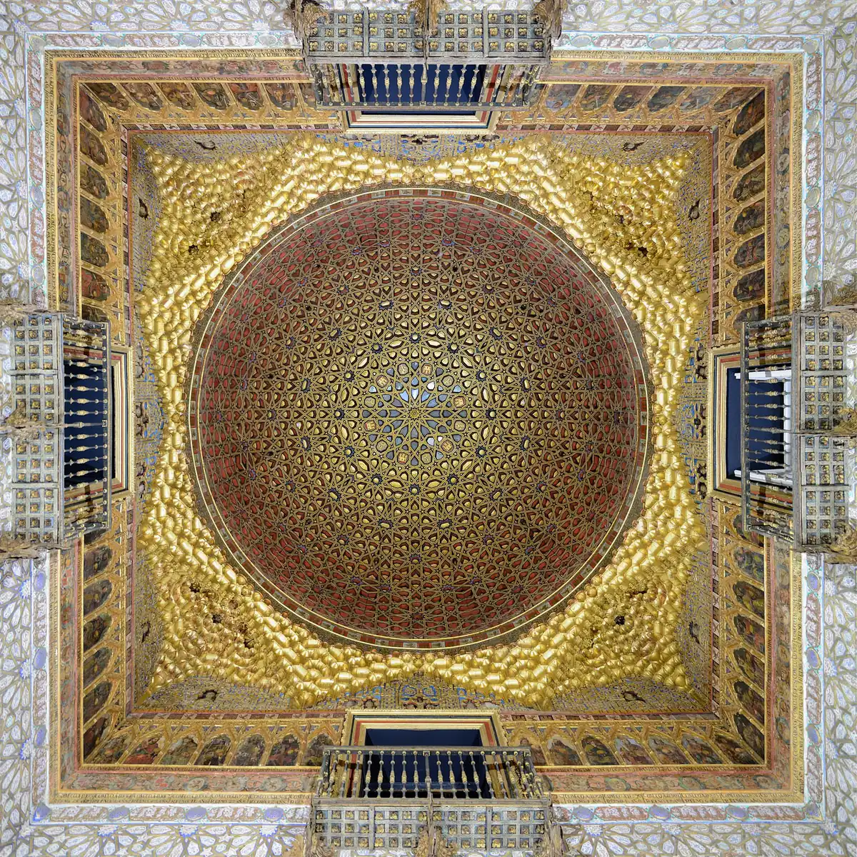 Gilded dome ceiling with carved plasterwork inside the Alcazar in Seville
