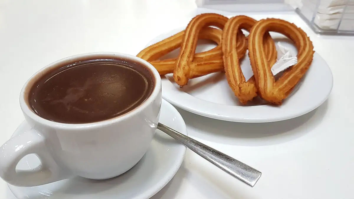Churros with a cup of thick hot chocolate