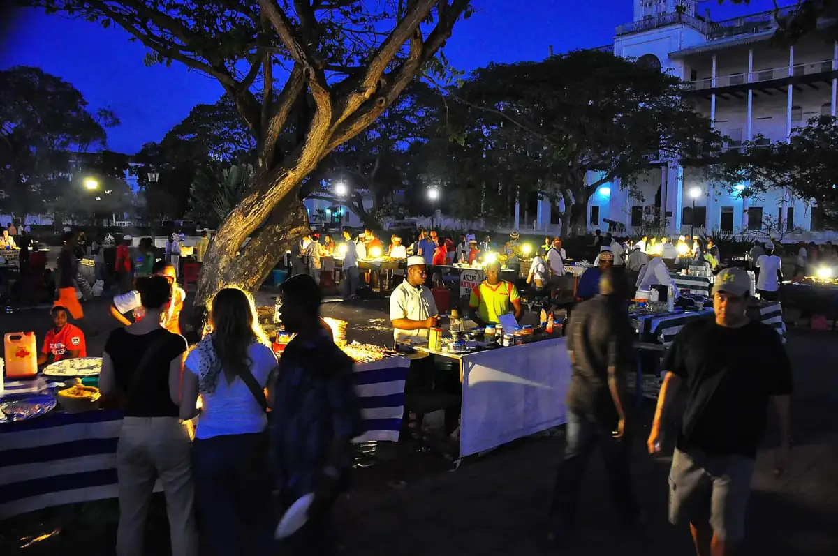 Stalls and crowds at the Forodhani Gardens night market after dark