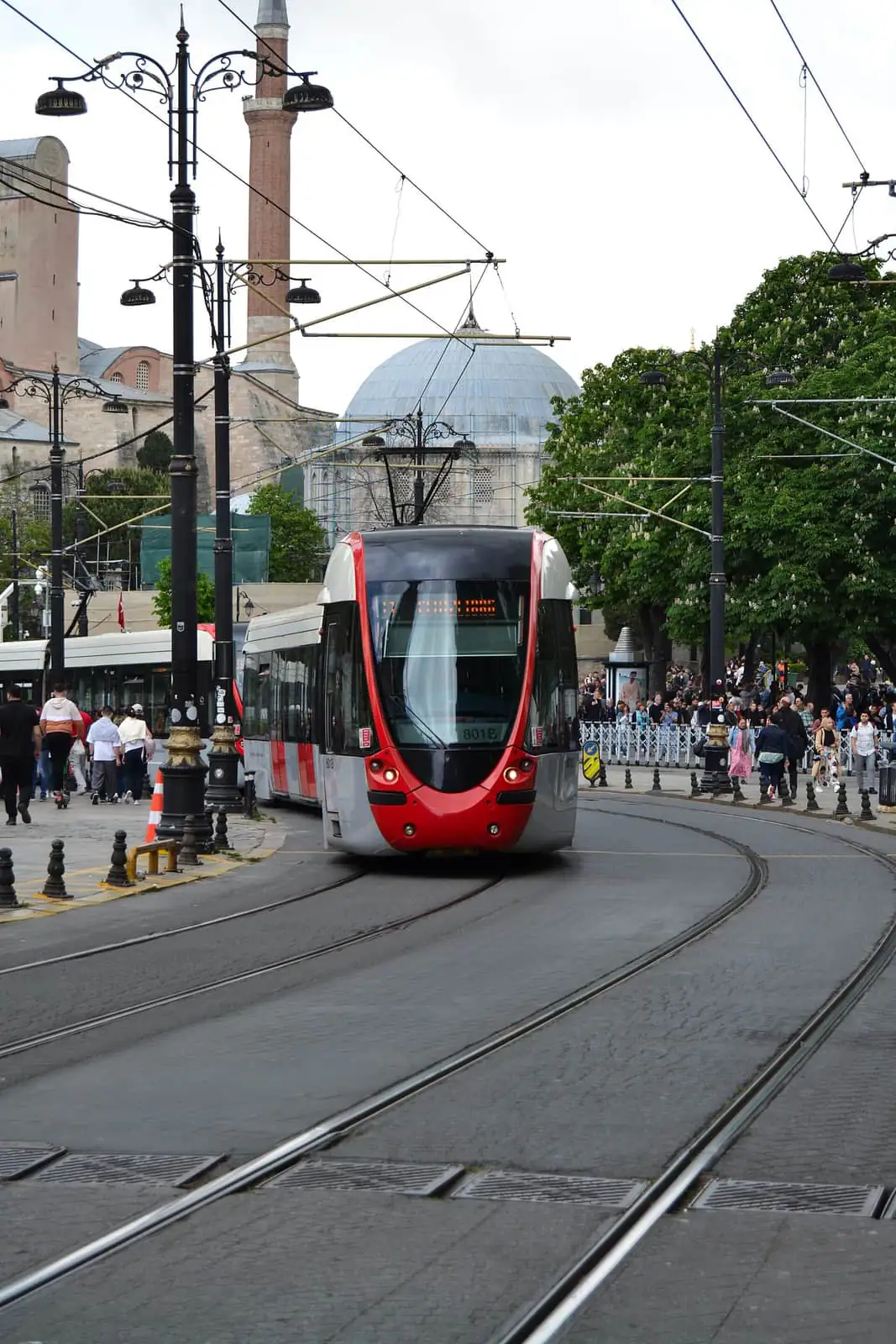 A red T1 tram passing Hagia Sophia in Sultanahmet