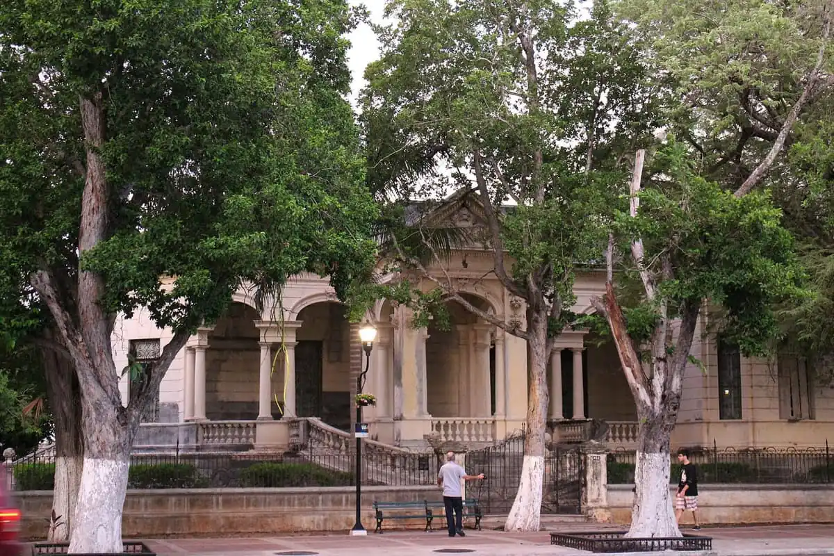A mansion on Paseo de Montejo behind the trees