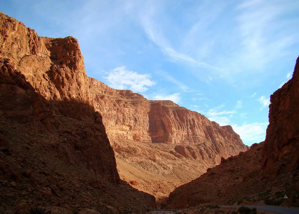 The Todra Gorge canyon walls rising above the road in the morning light