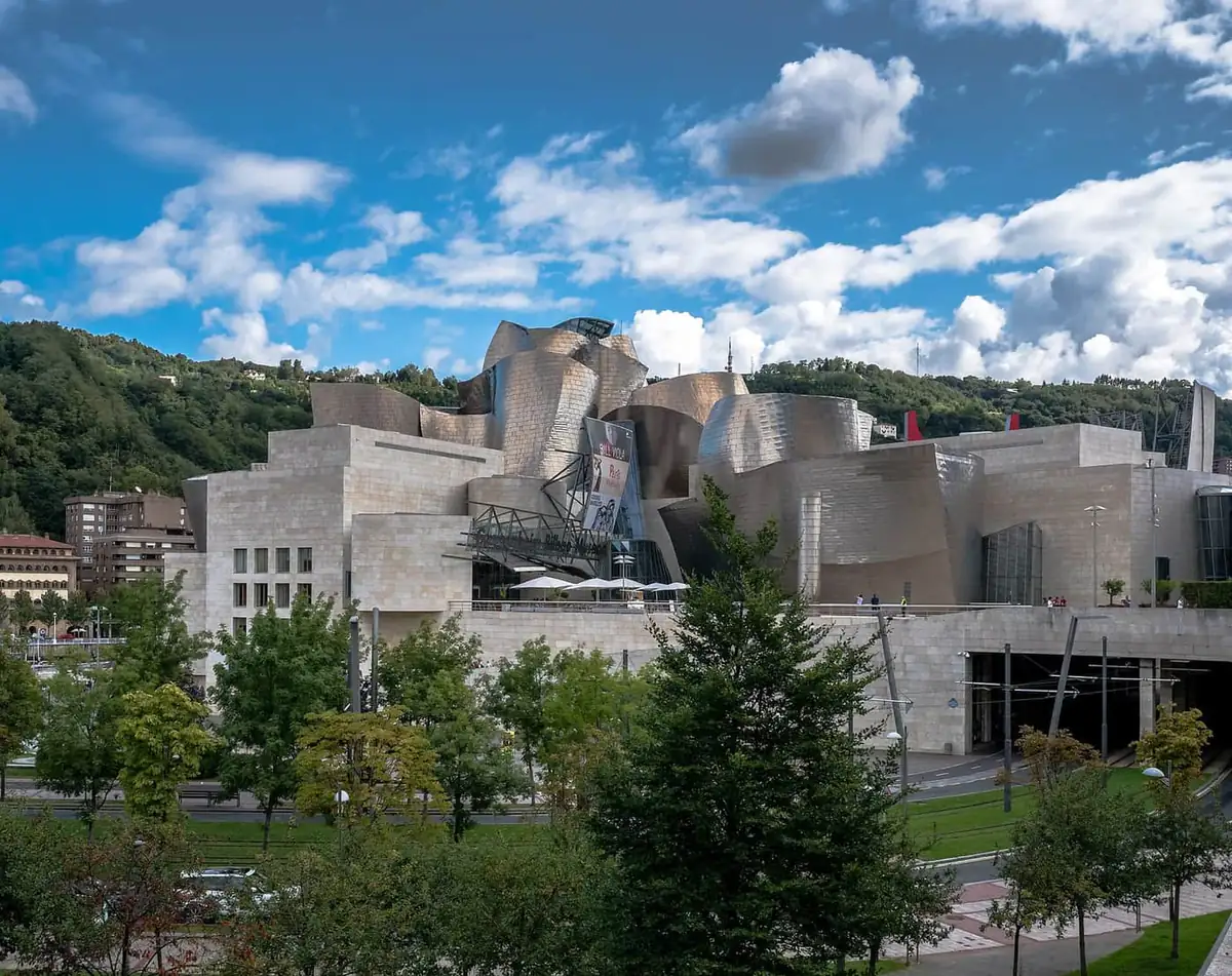 Titanium curves of the Guggenheim Museum in Bilbao, seen above the trees
