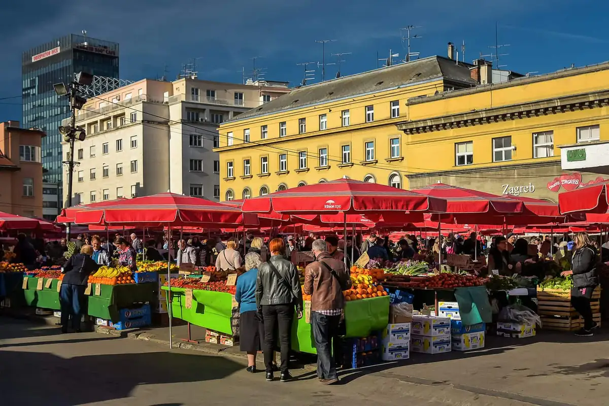 Shoppers at the red parasol stalls of Dolac market in Zagreb