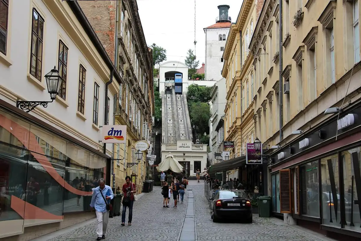 The blue funicular climbing from Tomićeva street towards Lotrščak Tower